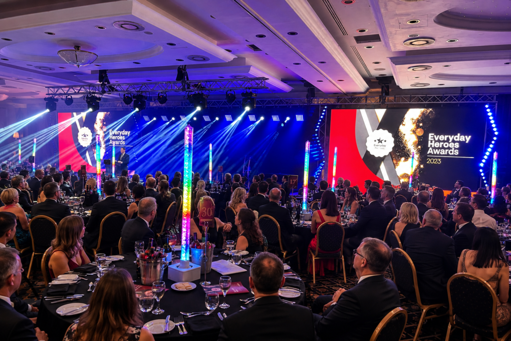 Corporate awards event production with LED screens, stage lighting and gala dinner setup