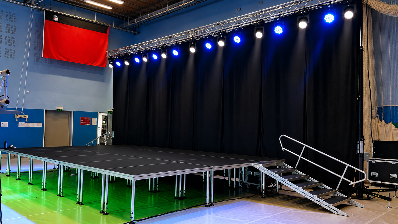 Large indoor event stage with LED screen, lighting, and professional AV setup
