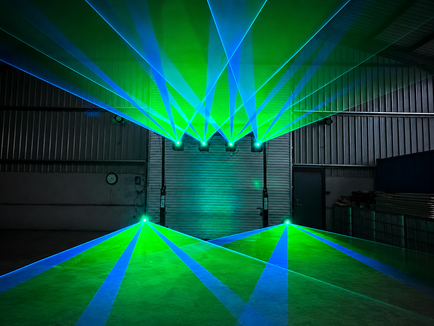 Green and blue event laser lighting display in warehouse venue