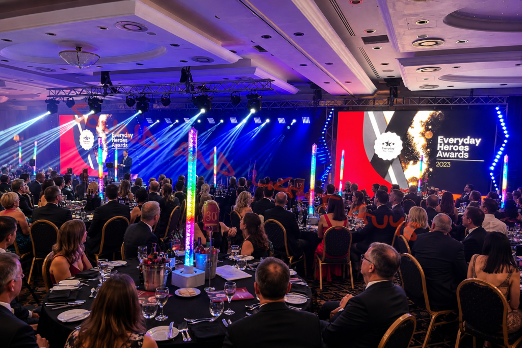 Corporate awards event production with LED screens, stage lighting and gala dinner setup